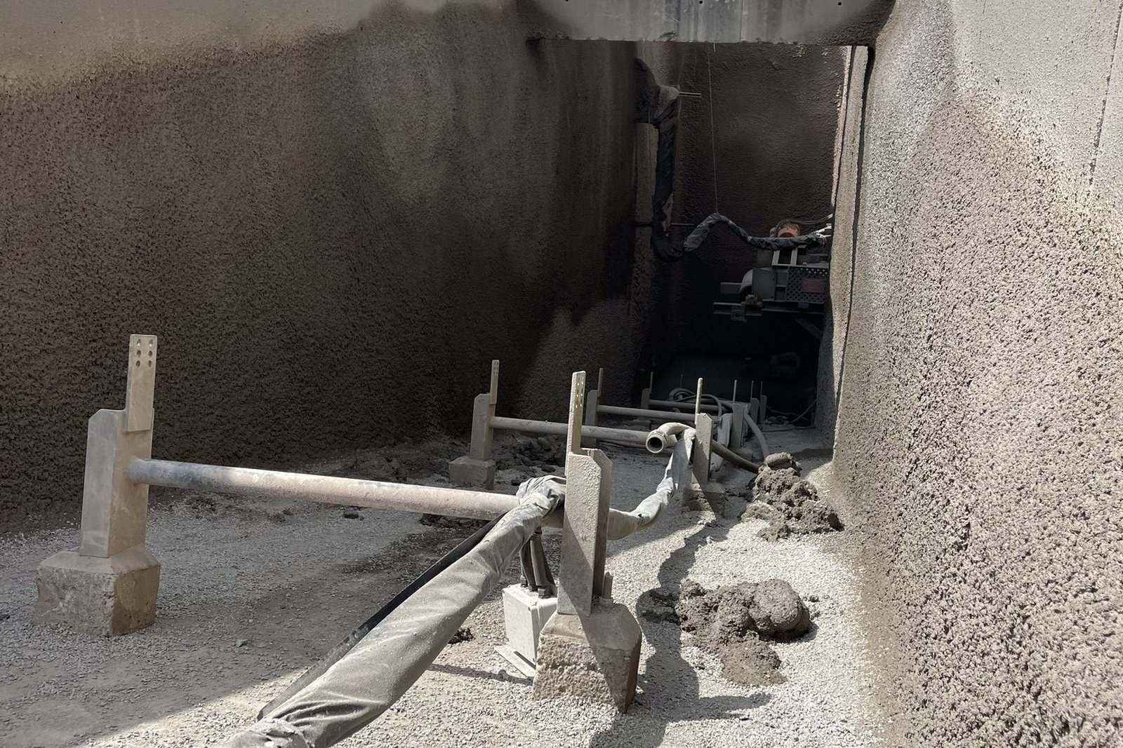 Shotcrete sprayed to a batch-plant bund wall during a plant shutdown