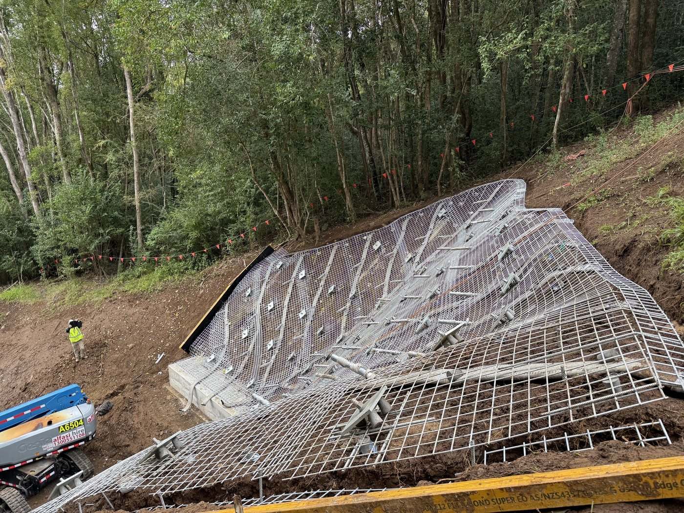 Mesh and anchors set out on a Lismore flood-restoration downslope before spraying