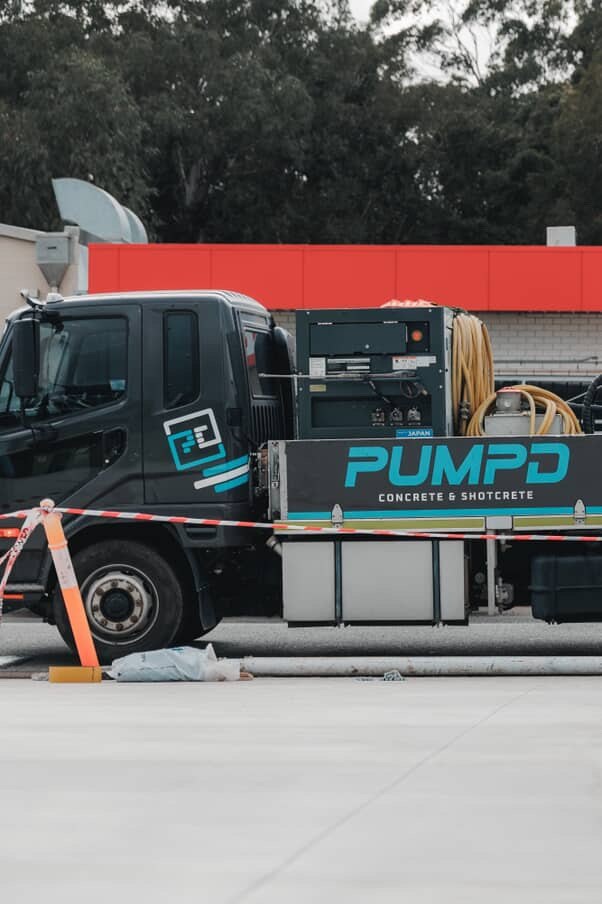 A Pumpd line pump truck set up and ready on a commercial site